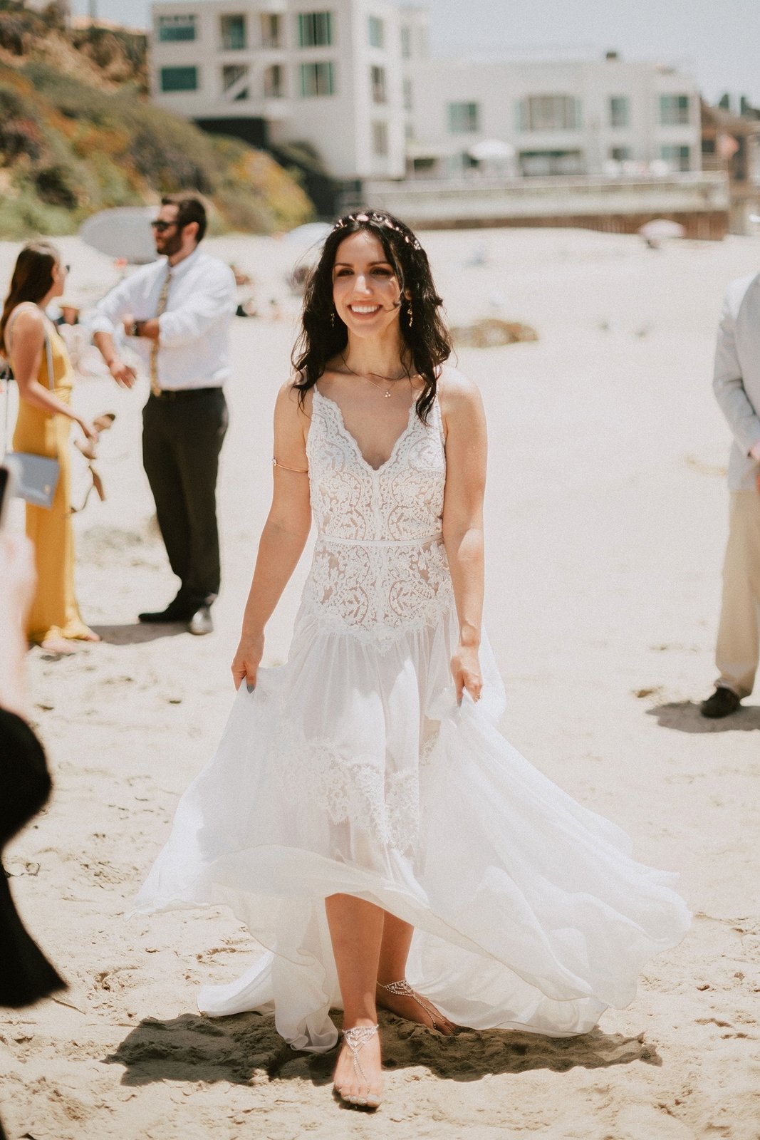 Real bride in a flowing boho lace wedding dress on the beach at a destination wedding, made to measure by Lace & Love