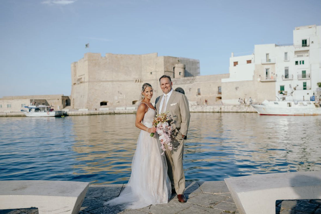 Real couple celebrating their vow renewal by the harbor in Italy