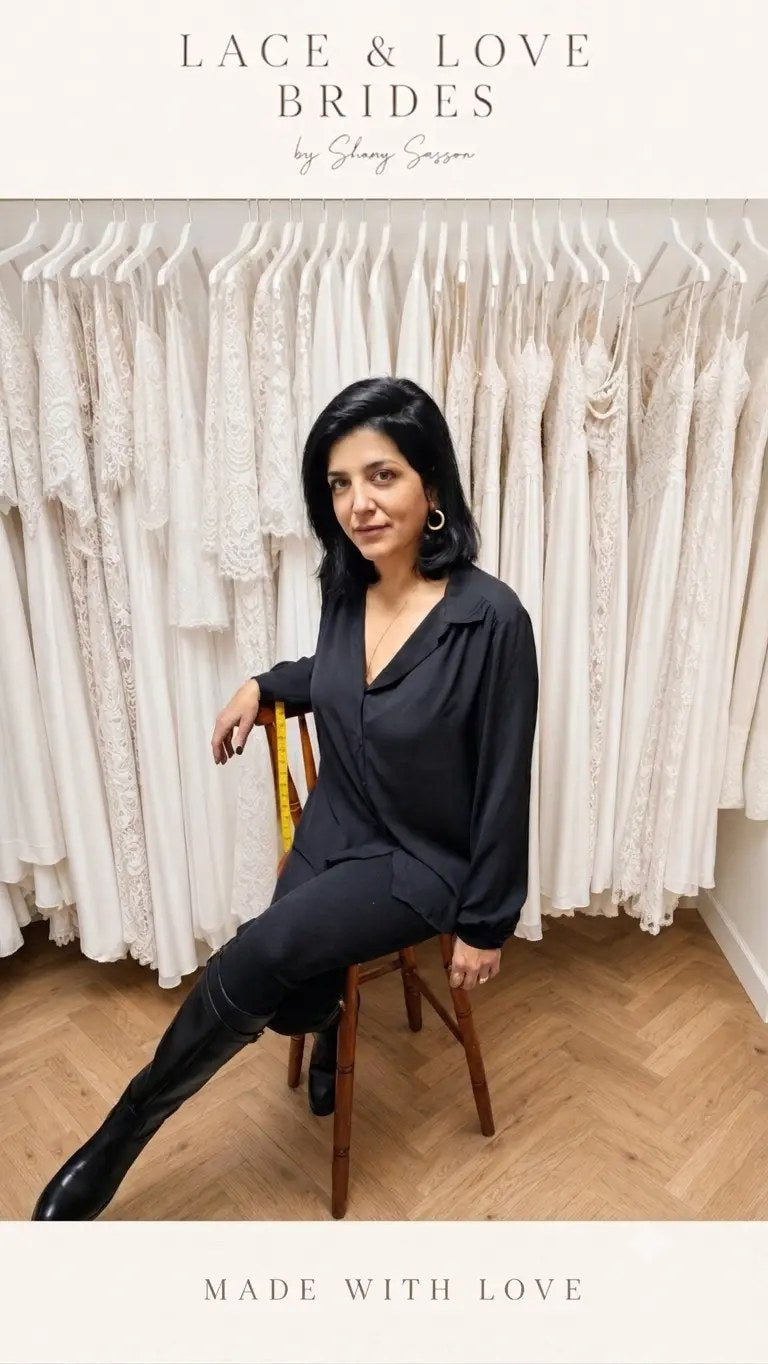 Shany Sasson with a tape measure in her bridal studio, in front of a rail of handmade lace wedding dresses
