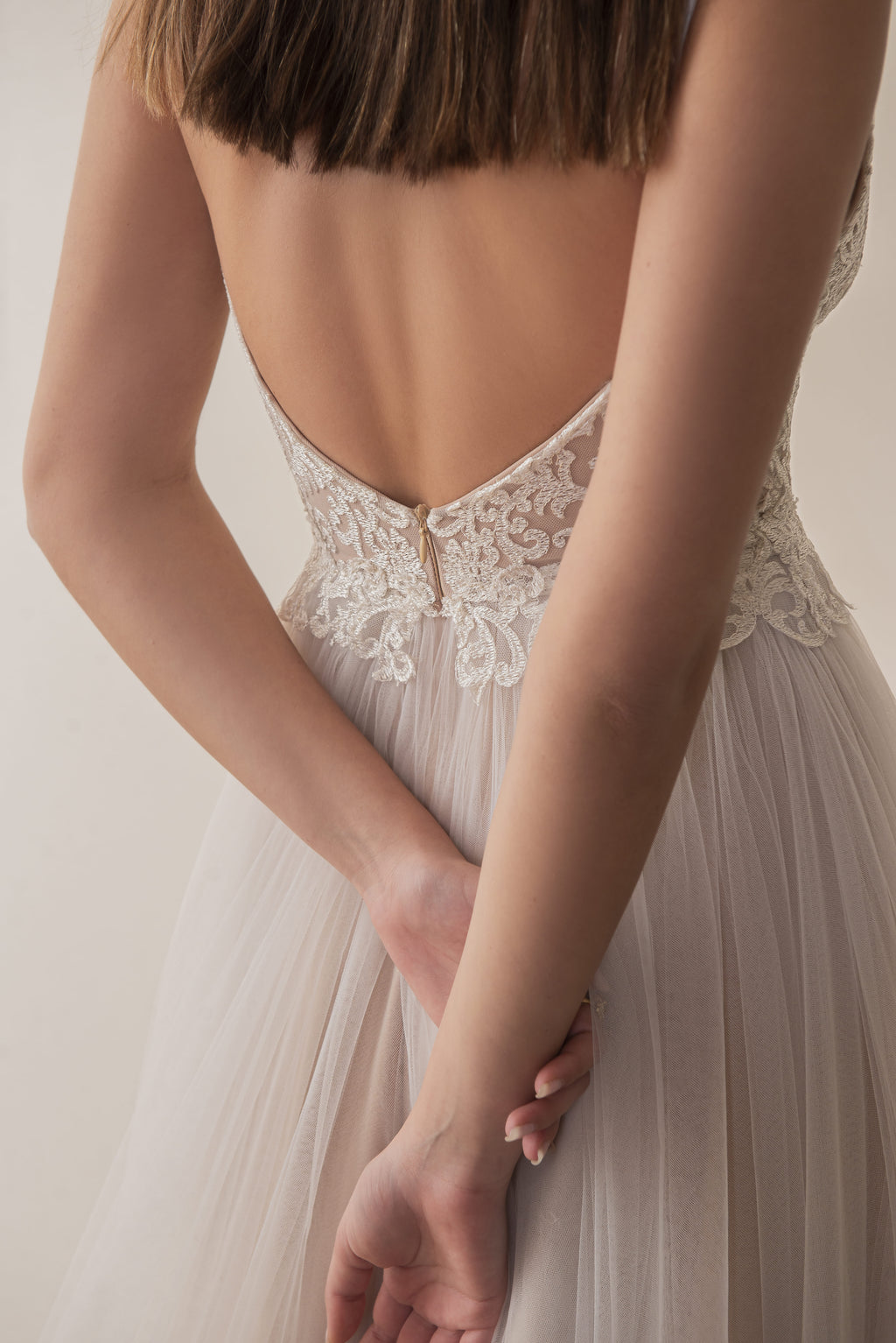 Close-up back view of a boho bridal gown with a low back