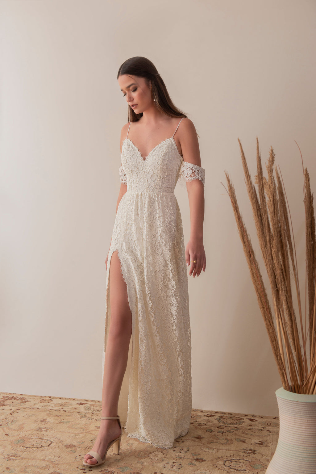 Full front view of a boho lace bridal gown with soft off-shoulder sleeves