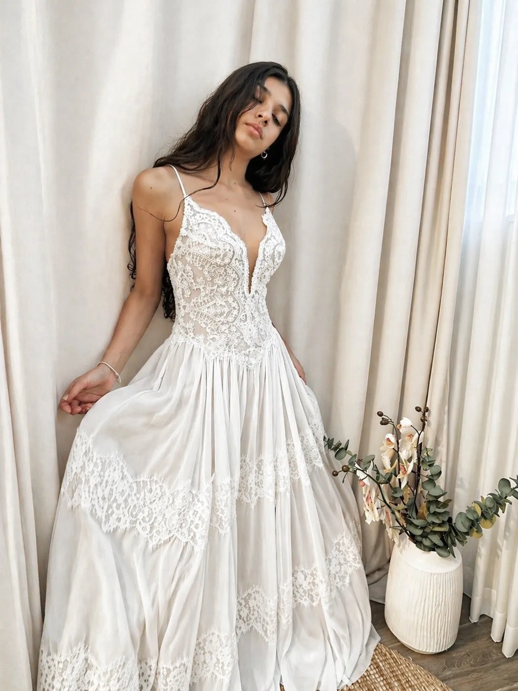 Boho lace bridal gown with delicate straps and a soft flowing silhouette