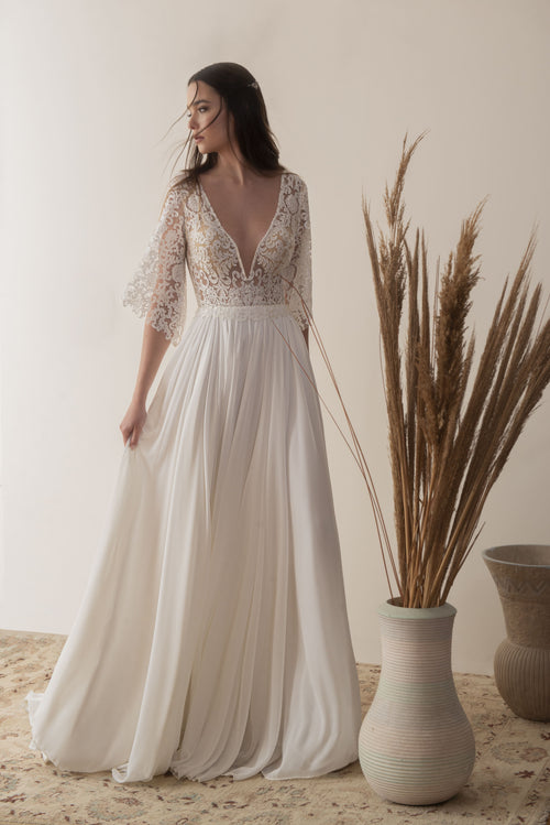 Boho lace wedding dress with deep V-neck and flowing chiffon skirt