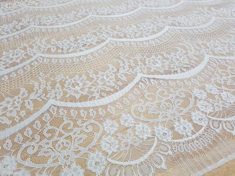 Close-up of delicate lace fabric on a boho wedding dress