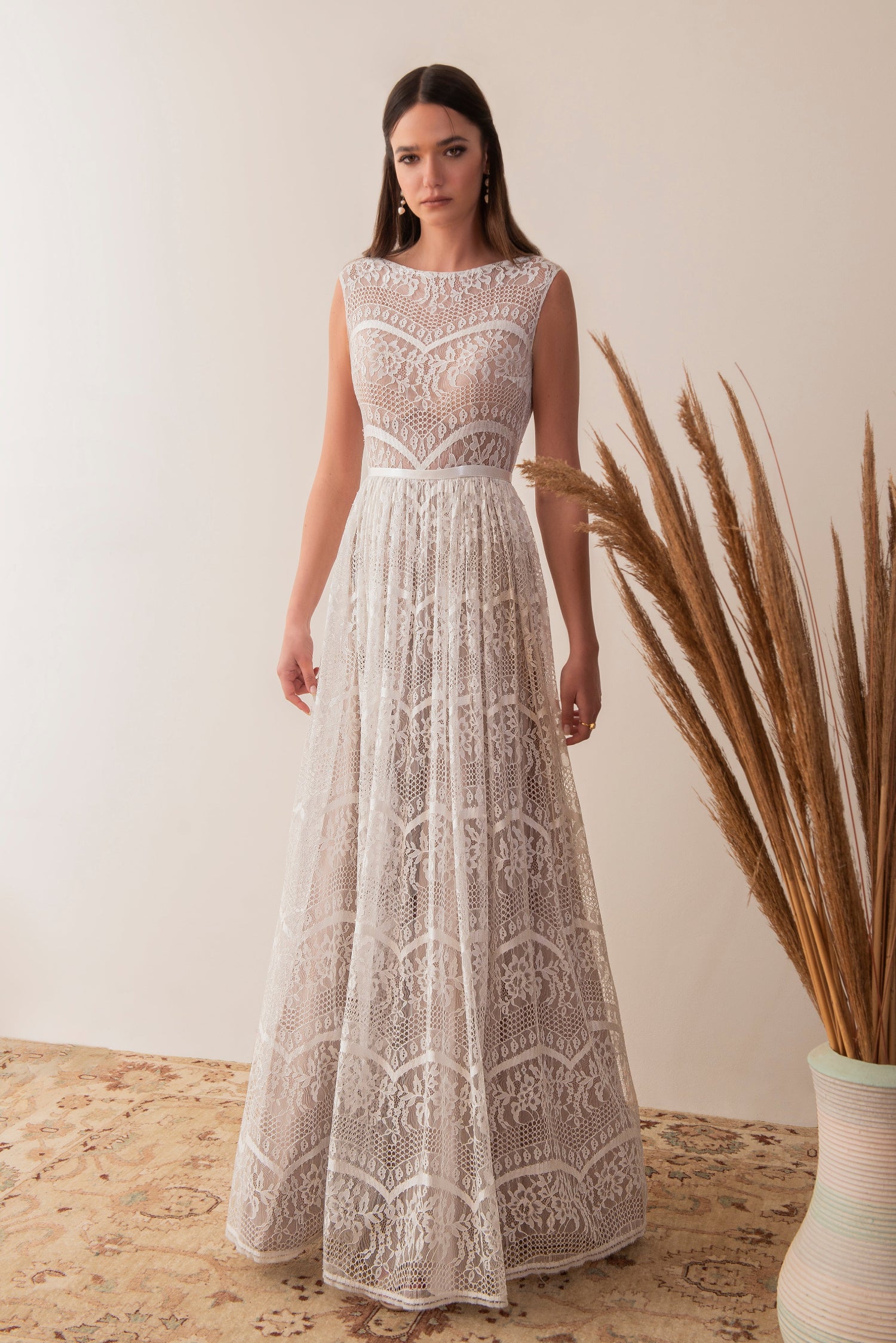 Full front view of a boho lace wedding dress with sleeveless bodice