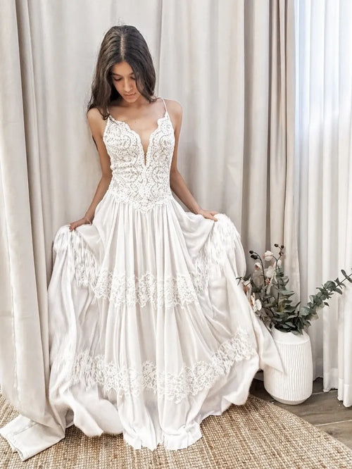 Bride wearing a romantic boho lace wedding dress with a flowing skirt