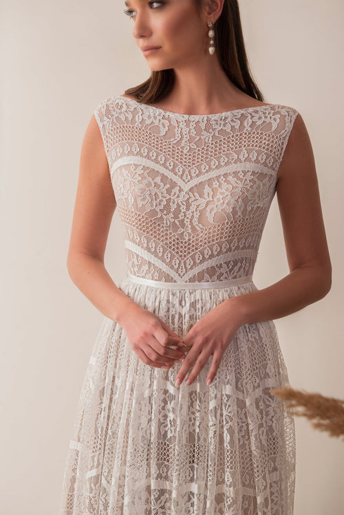 Bride wearing a boho lace wedding dress with high neckline
