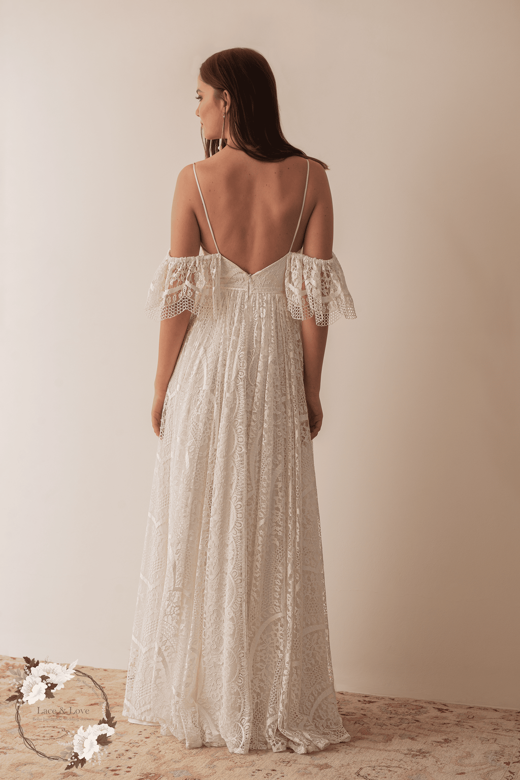 Back view of a boho lace wedding dress with low back and drop sleeves