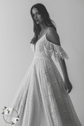 Boho lace wedding dress with off shoulder sleeves and flowing A-line skirt