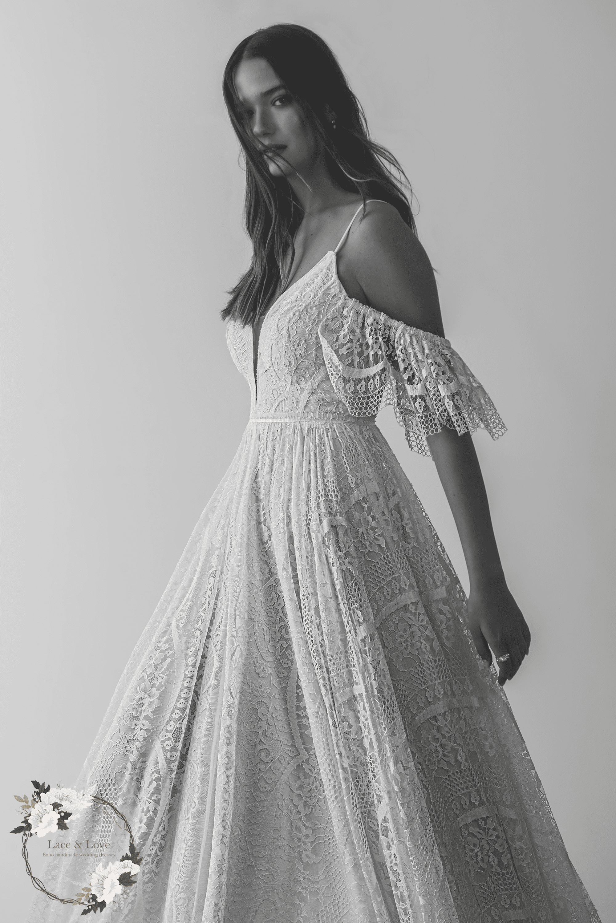 Boho lace wedding dress with off shoulder sleeves and flowing A-line skirt