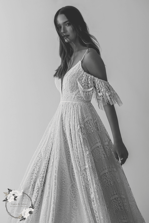 Boho lace wedding dress with off shoulder sleeves and flowing A-line skirt