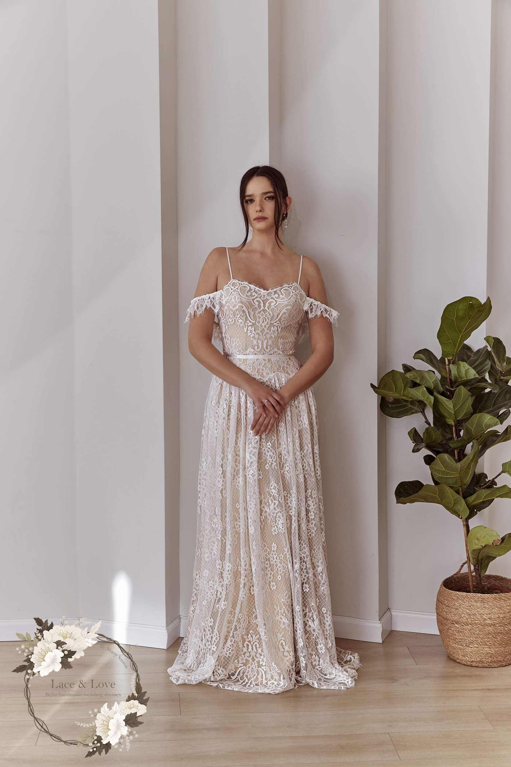 Boho lace wedding dress with off-shoulder sleeves and flowing skirt