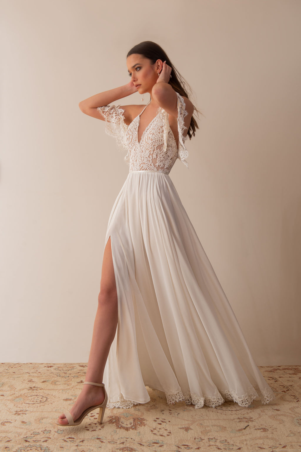Side view of a boho lace wedding dress with front slit and soft movement