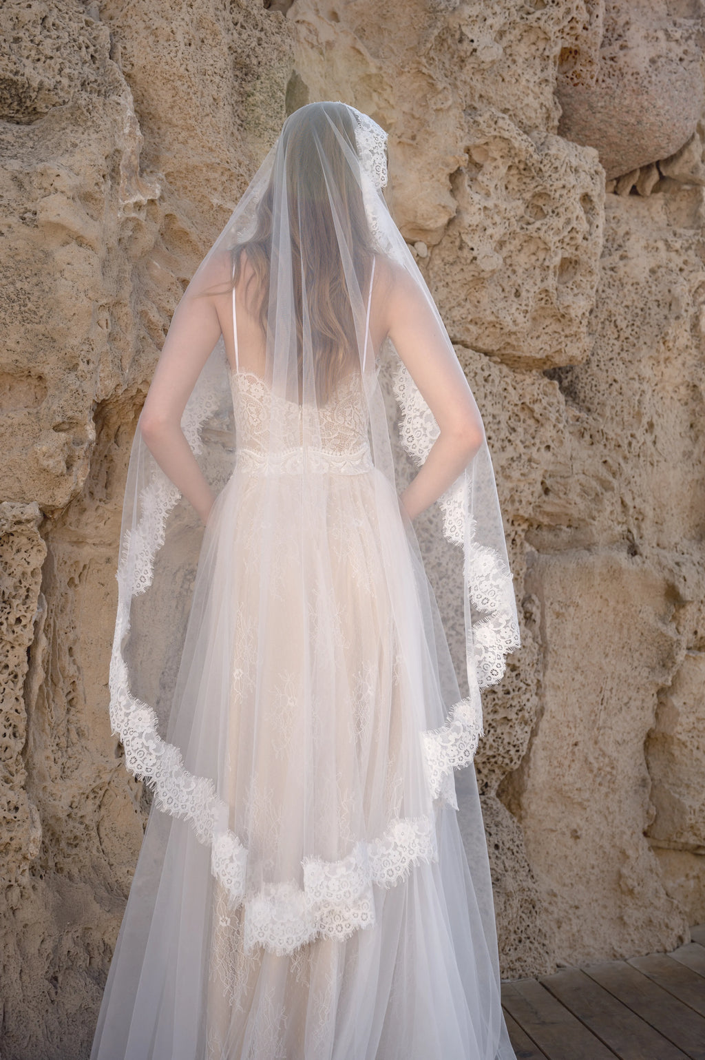 Back view of a boho wedding dress styled with a lace bridal veil