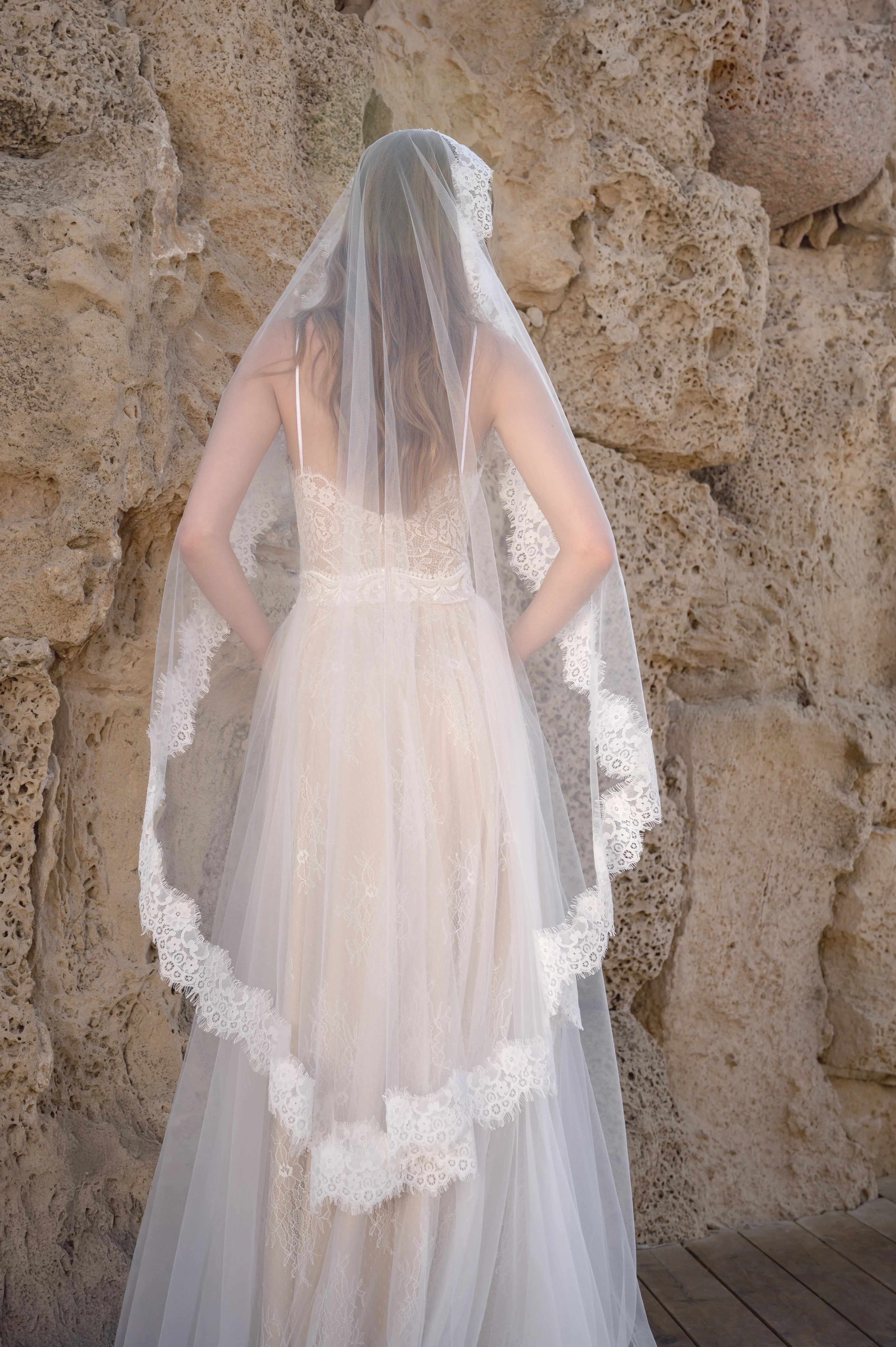 Back view of a boho wedding dress styled with a lace bridal veil