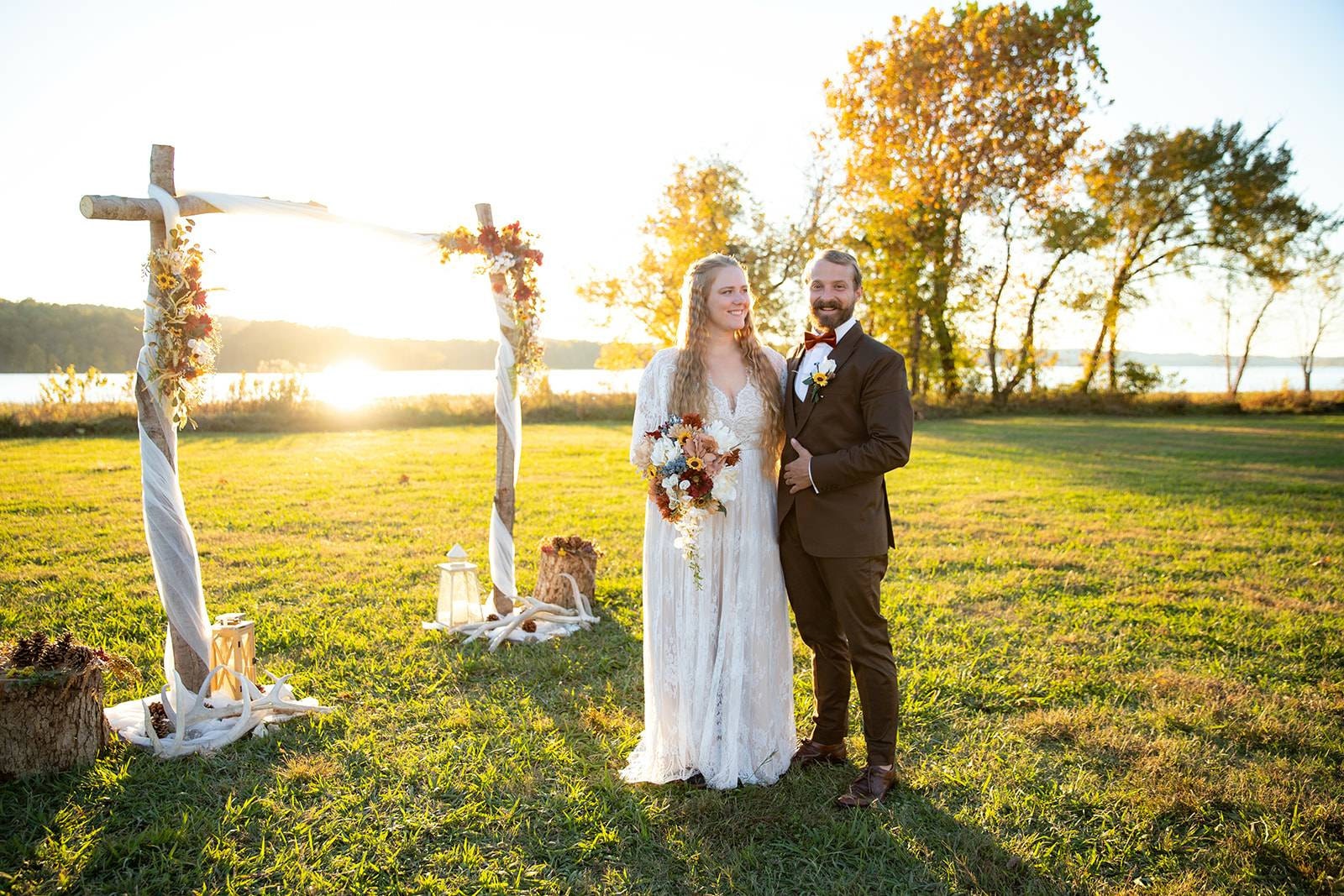 Bride in a boho wedding dress with her groom during a countryside wedding ceremony.