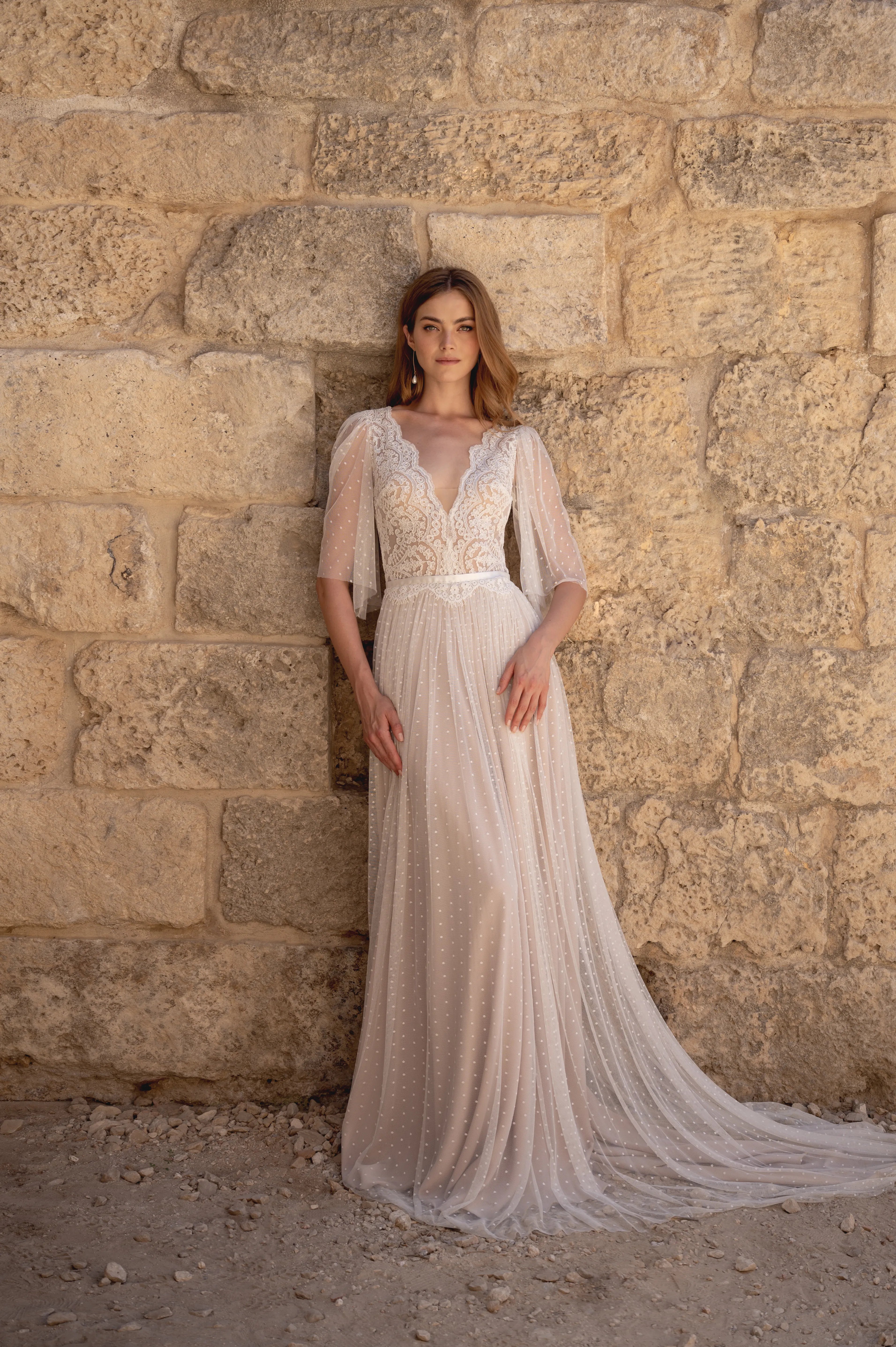 Bride wearing a boho wedding dress with a lace bodice and soft flowing skirt
