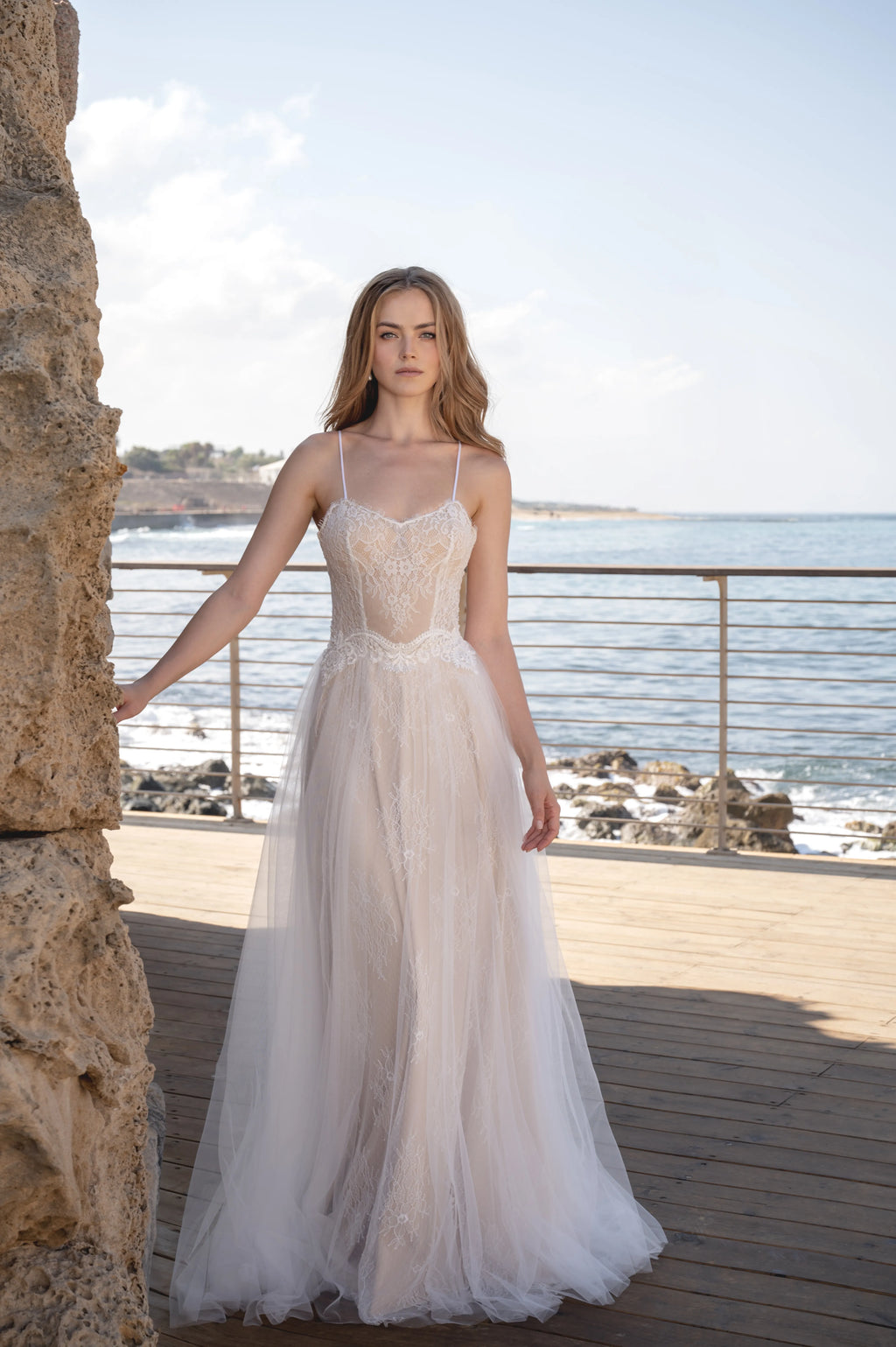 Full front view of a boho wedding dress with lace bodice and flowing skirt