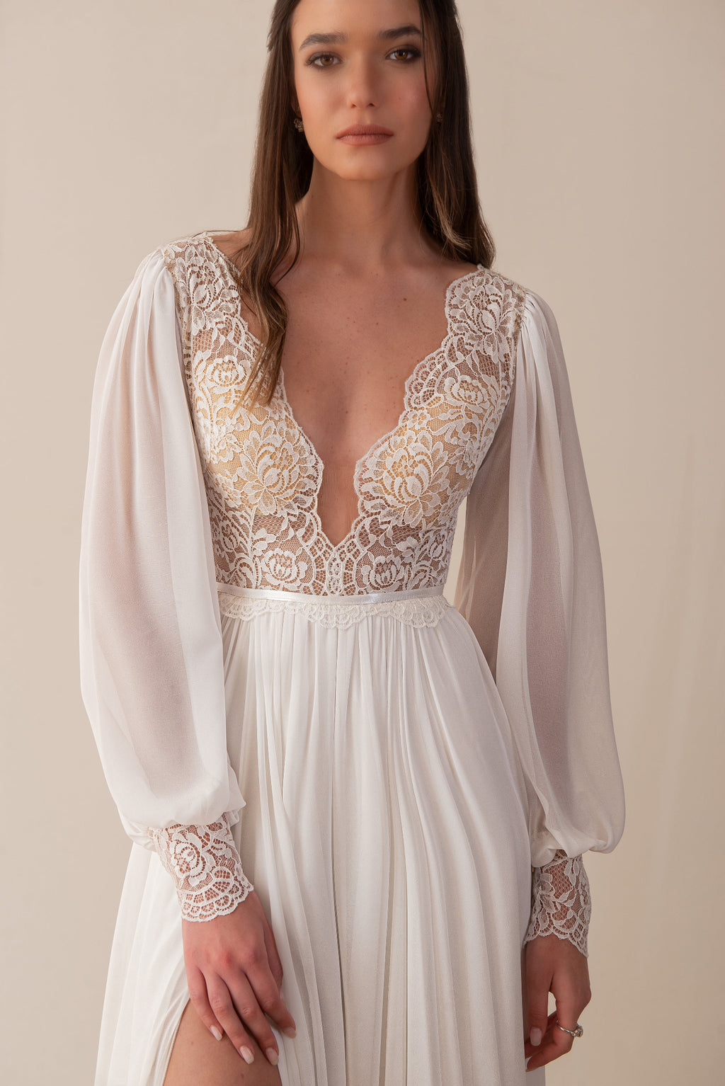 Close-up of a boho bridal gown with lace bodice and sheer sleeves