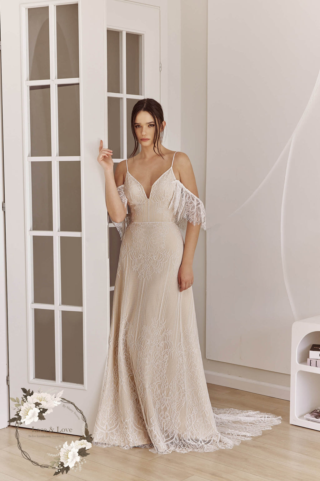 Bride wearing a fitted off-shoulder lace wedding dress