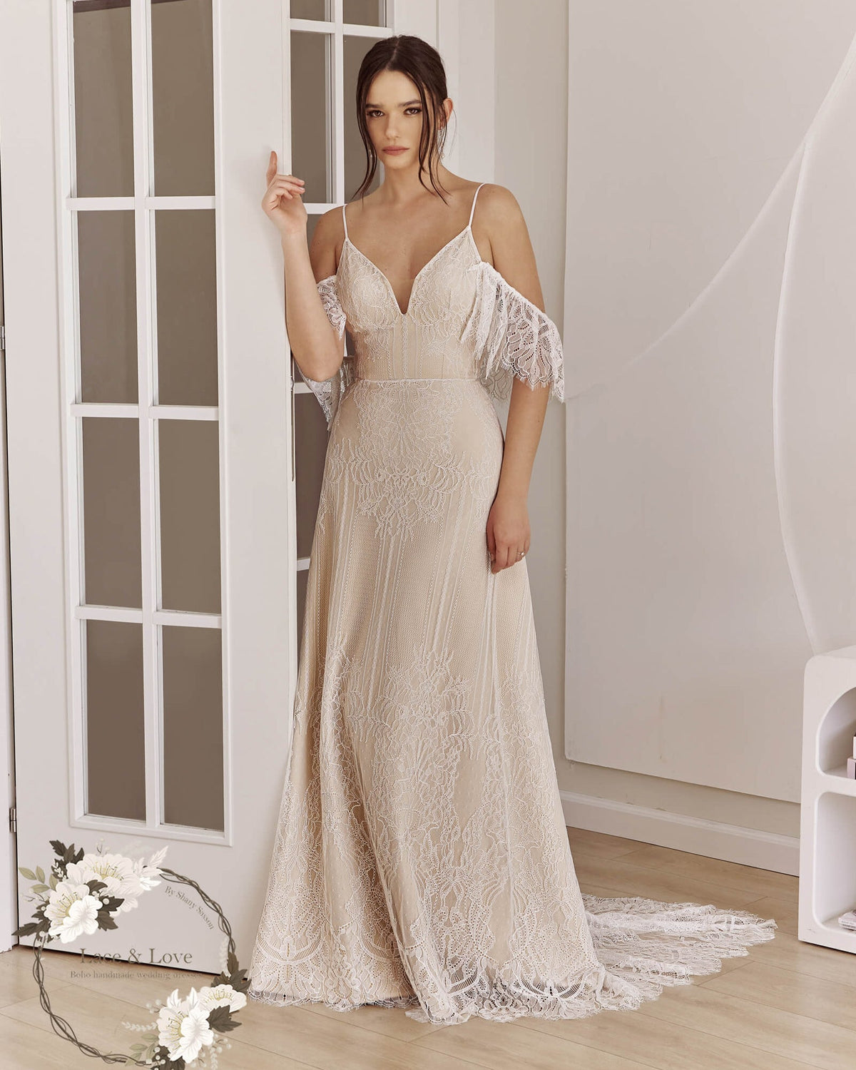 Bride wearing a fitted off-shoulder lace wedding dress