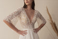 Bride wearing a boho lace wedding dress with flutter sleeves and V neckline