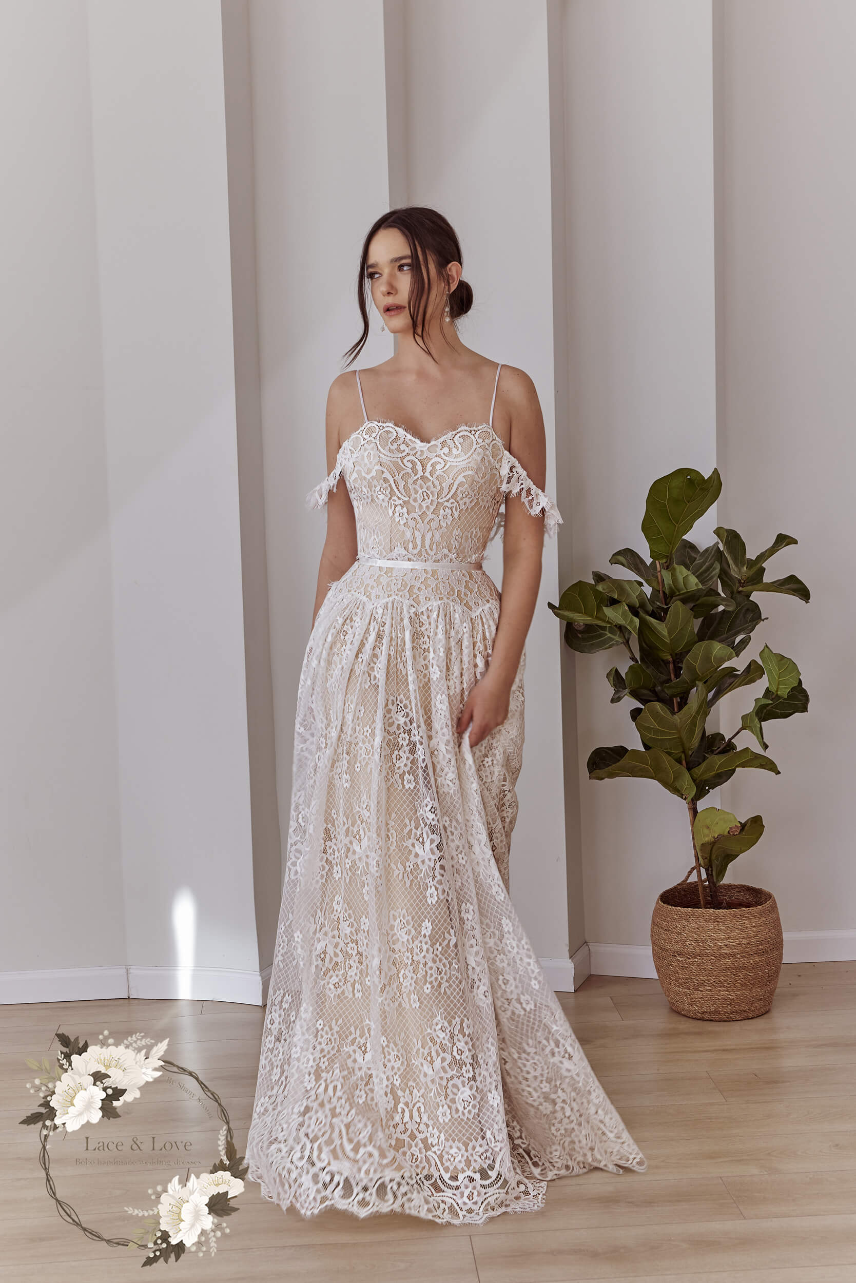 Full front view of an off-shoulder boho lace bridal gown