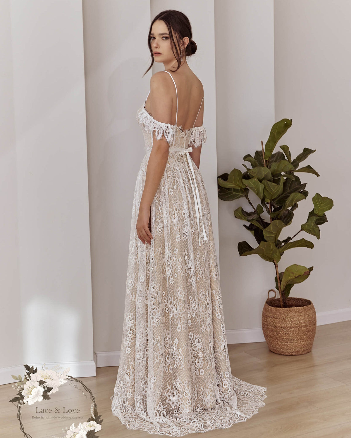 Side view of an off-shoulder boho lace wedding dress