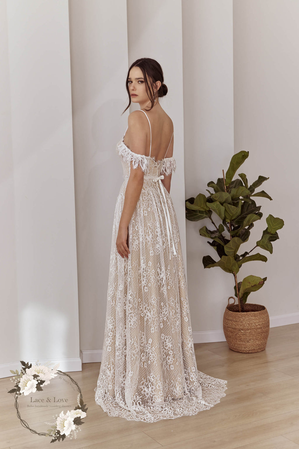 Side view of an off-shoulder lace bridal gown