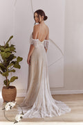 Back view of an off-shoulder lace wedding dress with flowing train