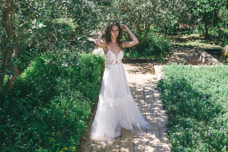 Real bride wearing a boho lace wedding dress with soft tulle skirt