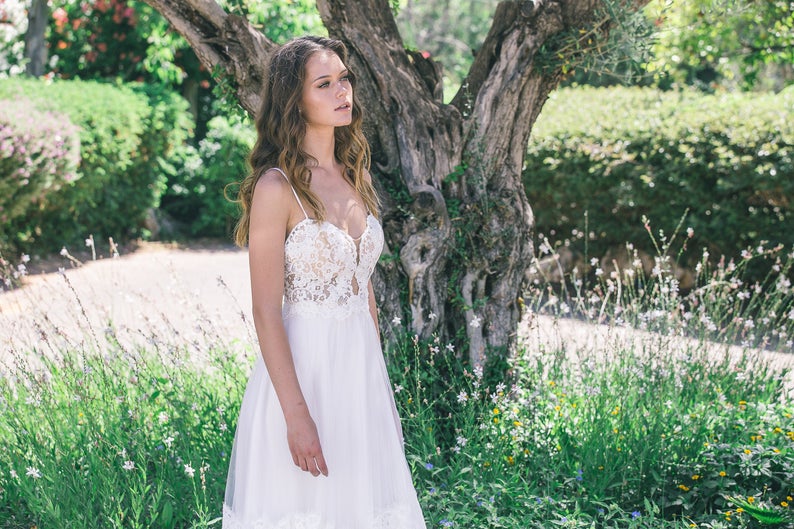 Real bride wearing a boho lace wedding dress with soft tulle skirt