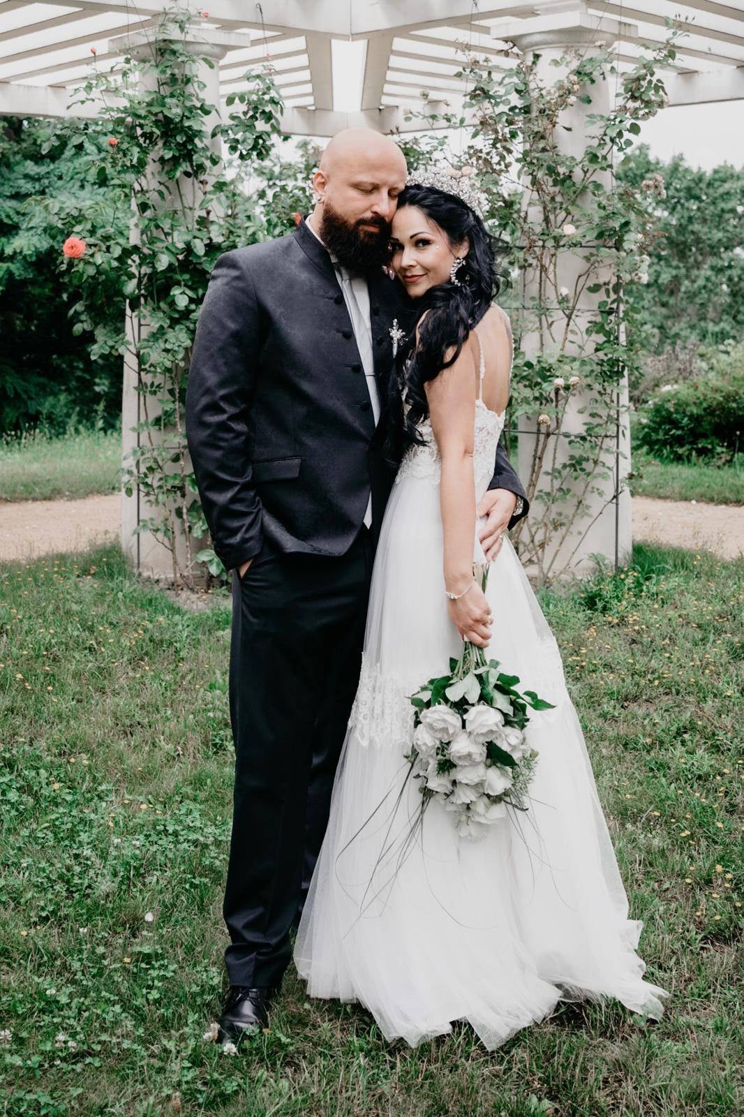 Real wedding couple with bride wearing a boho lace bridal gown
