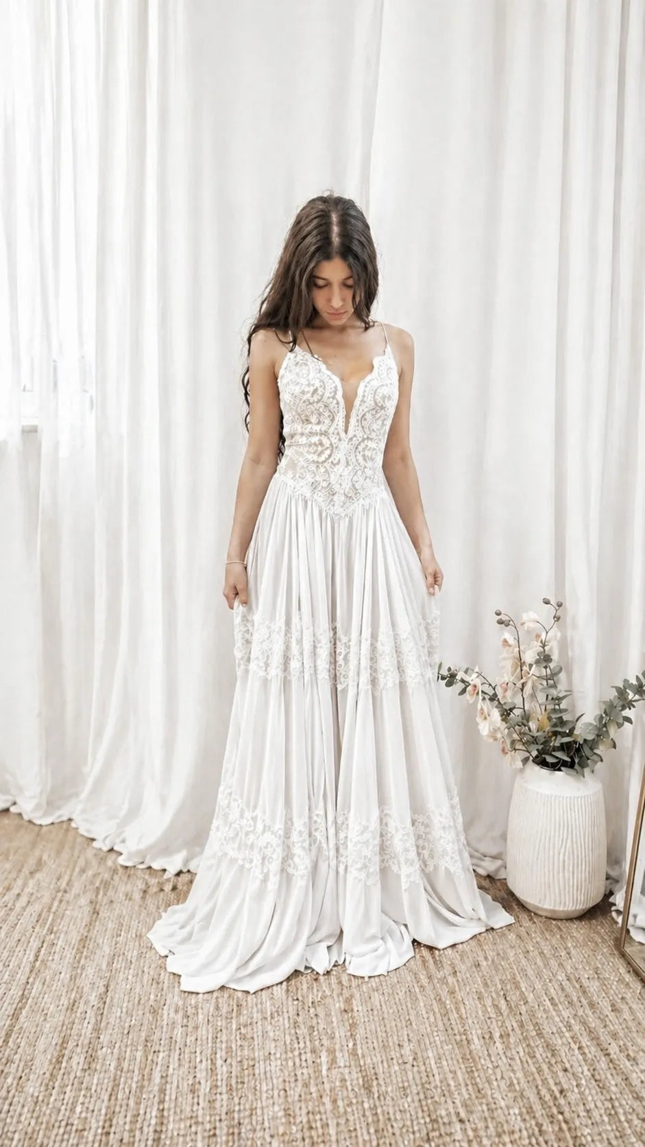Full view of a romantic boho wedding dress with lace details and soft movement