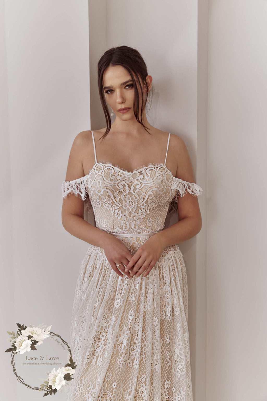 Close-up of an off-shoulder lace wedding dress bodice