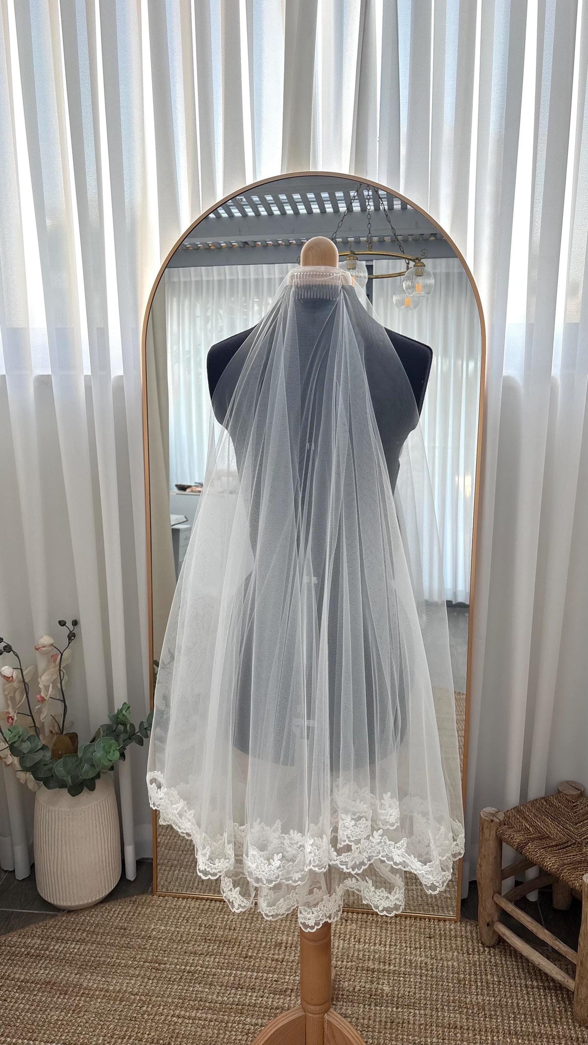 Two Tier Fingertip Wedding Veil, Floral Lace Edge, displayed on a dress form